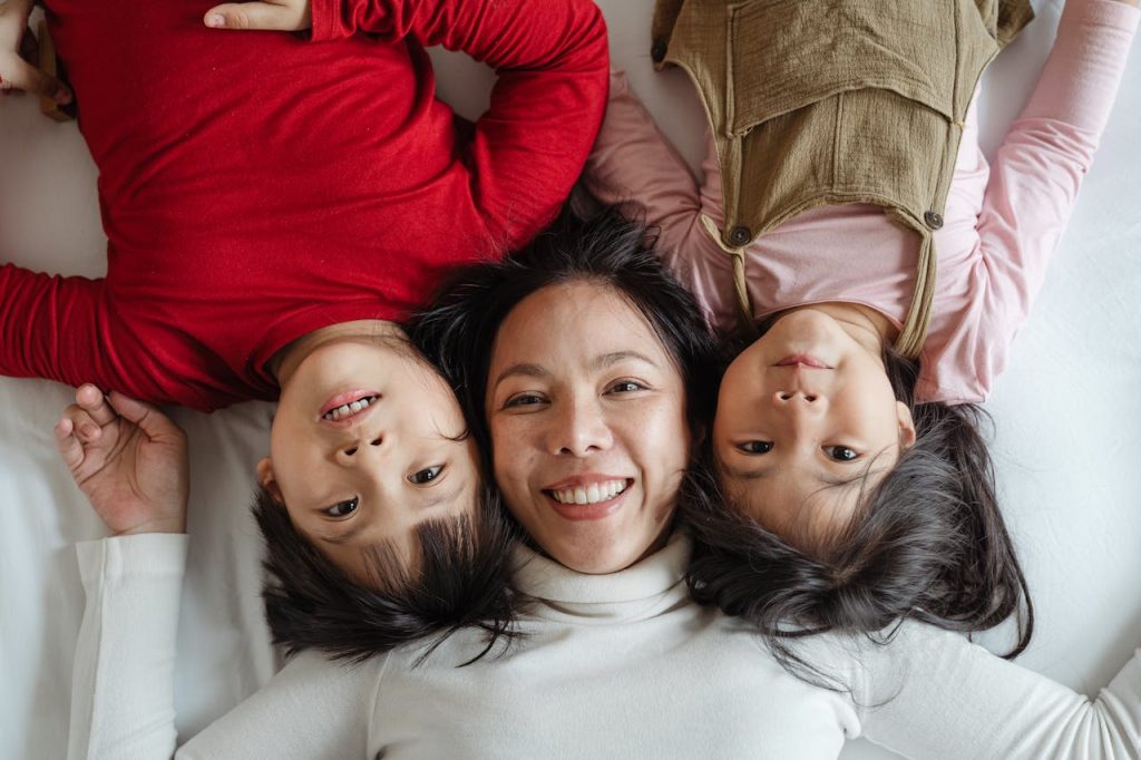 pexels-photo-4473870 Photo of Woman and Her Children Lying on Bed